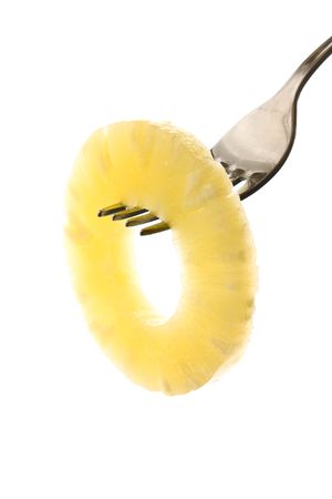 sliced pineapple on a fork isolated on white backgroundの写真素材