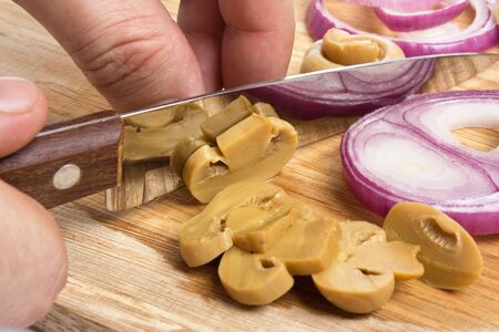 sliced mushrooms and onions on a cutting boardの写真素材