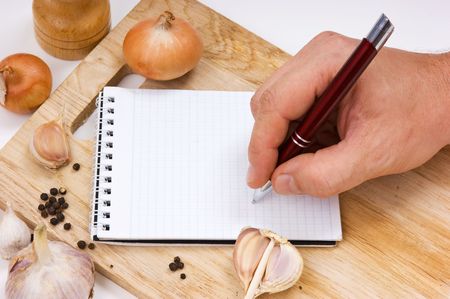 notebook for culinary recipes on a cutting boardの写真素材