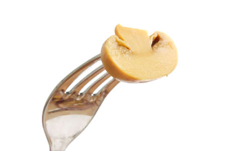 mushroom on a fork isolated on white backgroundの写真素材