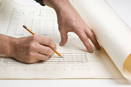 hand draws a pencil on the drawingの写真素材