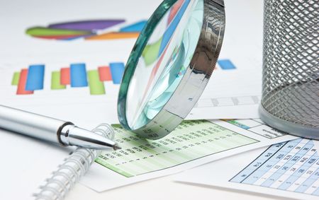 pen, magnifying glass and the working paper with a diagramの写真素材