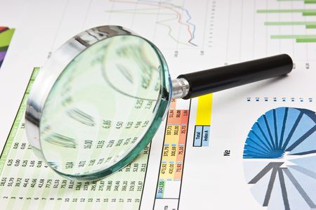 magnifying glass and the working paper with a diagram