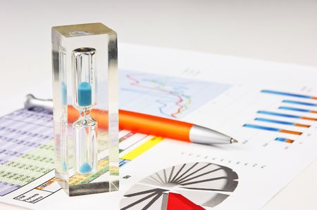 an hourglass and the working paper with a diagram