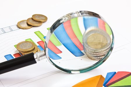 magnifying glass and the working paper with coinssの写真素材