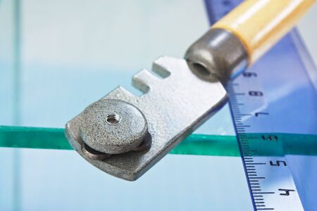 glass cutter and  ruler on the glassの写真素材