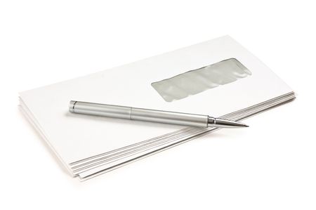 stack of mail envelopes and a pen isolated on white backgroundの写真素材