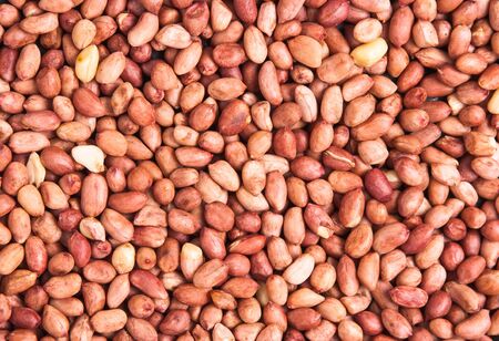 background of a heap of roasted peanutsの写真素材
