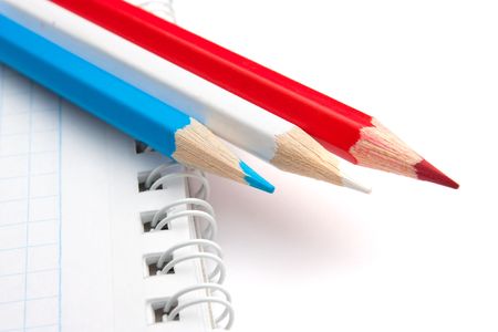 colored pencils and notebook isolated on a white  backgroundの写真素材