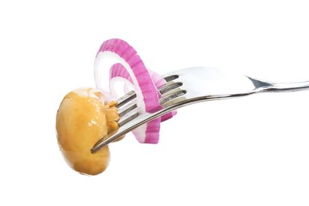 mushroom on a fork isolated on white backgroundの写真素材
