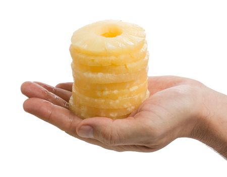 slices of pineapple in the palm  isolated on white backgroundの写真素材