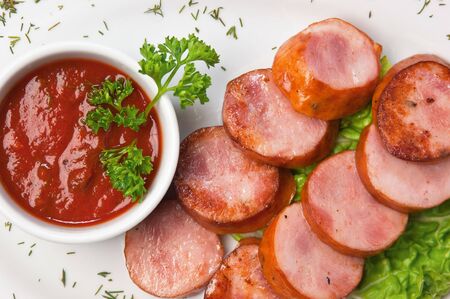 chopped sausages fried with vegetables and spicesの写真素材