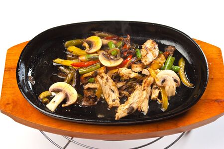 grilled meat with mushrooms and vegetables in a boiling panの写真素材