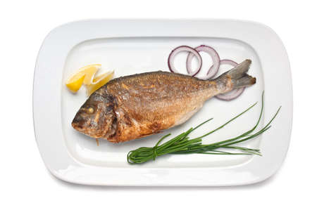 dish of fried fish with onions  isolated on white backgroundの写真素材