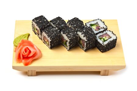 Traditional Asian food sushi on wooden plate isolated on white backgroundの写真素材