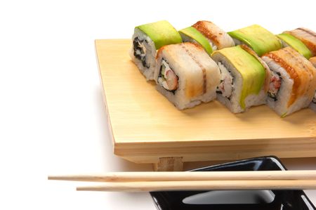 Traditional Asian food sushi on wooden plate isolated on white backgroundの写真素材