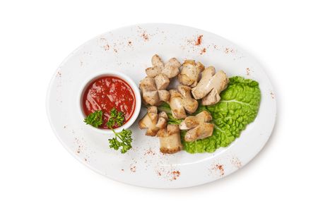 chopped sausages fried with vegetables and spices  isolated on white backgroundの写真素材