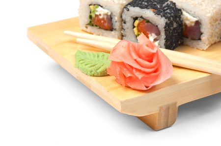 Traditional Asian food sushi on wooden plate isolated on white backgroundの写真素材