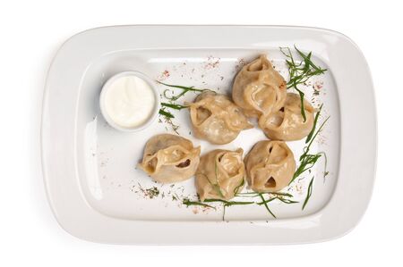 dish of ravioli with sour cream  isolated on white backgroundの写真素材