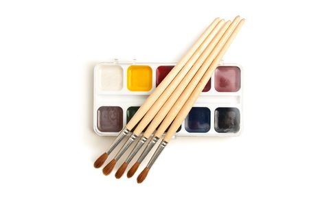 watercolor paints and  brushes isolated on a white  backgroundの写真素材