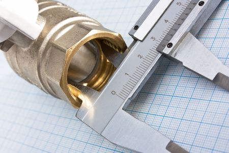 water inlet valve  on a background of graph paperの写真素材