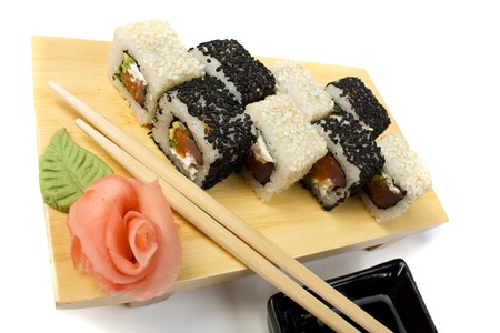 Traditional Asian food sushi on wooden plate isolated on white backgroundの写真素材