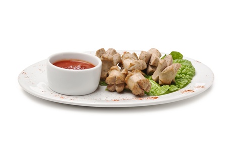 chopped sausages fried with vegetables and spices  isolated on white backgroundの写真素材