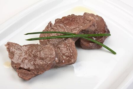 dishes of roast meat with vegetables and spicesの写真素材