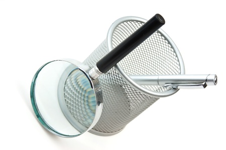 basket for pencils and magnifying glassの写真素材