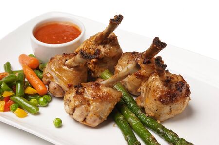 dishes of roast meat with vegetables and spices  isolated on white backgroundの写真素材