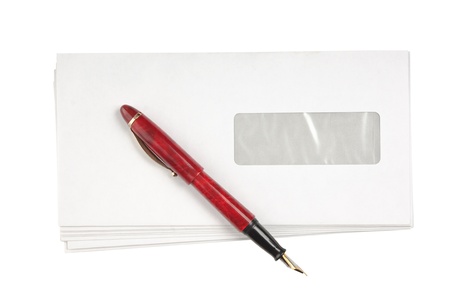 stack of mail envelopes and a pen isolated on white backgroundの写真素材