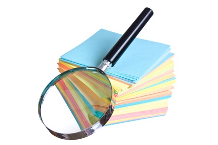 magnifying glass and a stack of paper isolated on a white  backgroundの写真素材