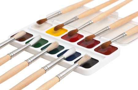 watercolor paints and  brushes isolated on a white  backgroundの写真素材