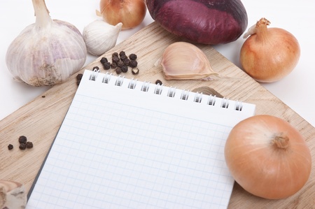 notebook for culinary recipes on a cutting boardの写真素材