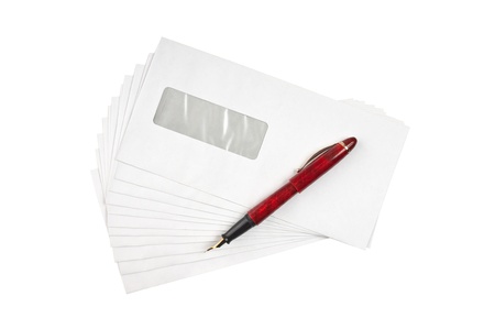 stack of mail envelopes and a pen isolated on white backgroundの写真素材