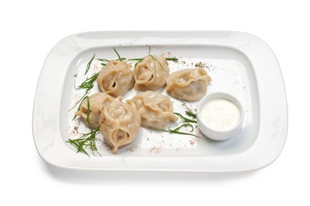 dish of ravioli with sour cream  isolated on white backgroundの写真素材