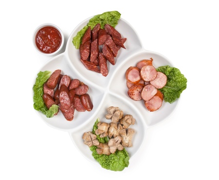 chopped sausages fried with vegetables and spices  isolated on white backgroundの写真素材