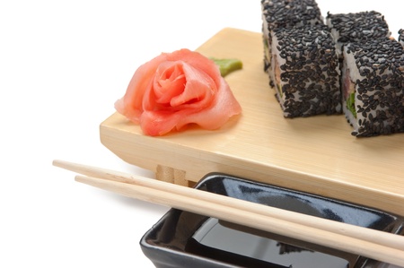 Traditional Asian food sushi on wooden plate isolated on white backgroundの写真素材