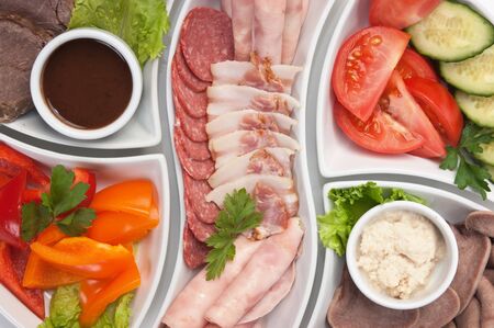 dish of assorted sausages and vegetablesの写真素材