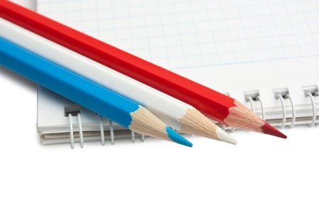 colored pencils and notebook isolated on a white  backgroundの写真素材