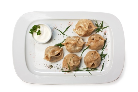 dish of ravioli with sour cream  isolated on white backgroundの写真素材