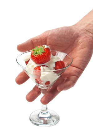 Ice cream with strawberries in hand  isolated on whiteの写真素材
