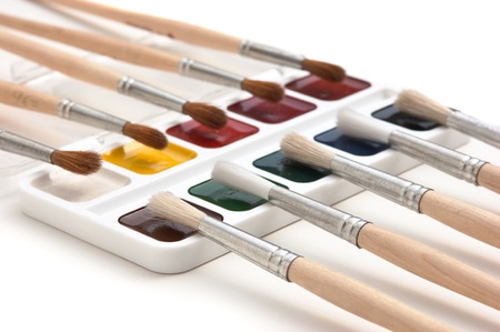 watercolor paints and  brushes isolated on a white  backgroundの写真素材