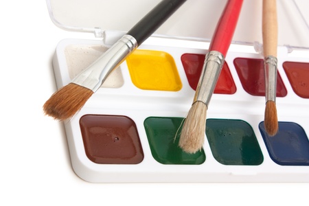 watercolor paints and  brushes isolated on a white  backgroundの写真素材