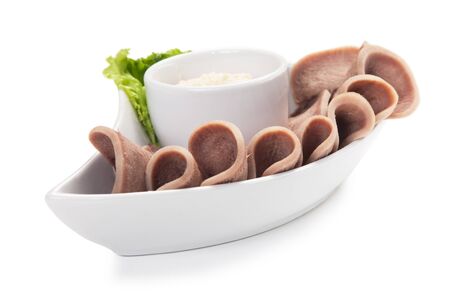 Boiled beef tongue with sauce isolated on white backgroundの写真素材
