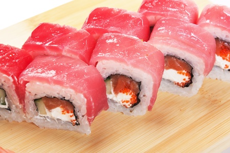 Asian food sushi on wooden plate isolated on white backgroundの写真素材