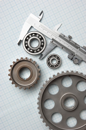 caliper with gears and bearings on graph paperの写真素材