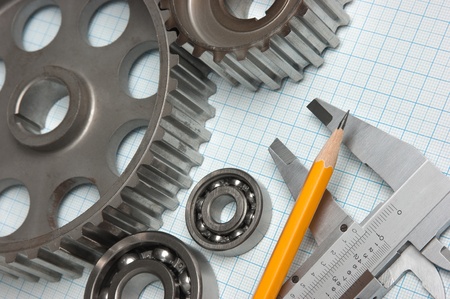 caliper with gears and bearings on graph paperの写真素材