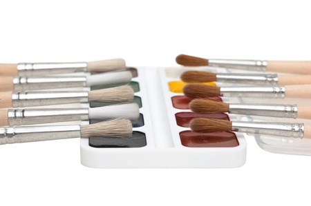 watercolor paints and  brushes isolated on a white  backgroundの写真素材