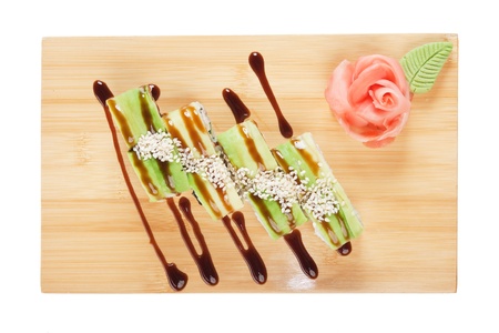 Asian food sushi on wooden plate isolated on white backgroundの写真素材